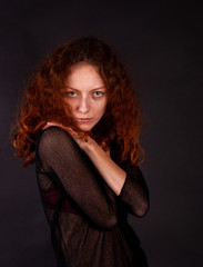 Fototapeta premium Beautiful red-haired woman with fair skin and curly hair, portrait