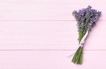Beautiful lavender bouquet on pink wooden background, top view. Space for text