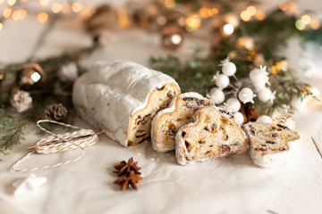 Christmas stollen on wooden background. Traditional Christmas festive pastry dessert. Stollen for Christmas.