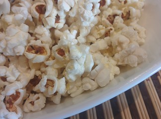 popcorn on white plate close up  food ingredient healthy snack background texture stay home cinema...