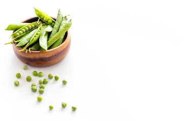 Sweet green peas in bowl on kitchen table desk