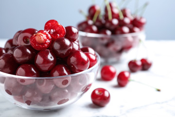 Sweet juicy cherries on white marble table, closeup