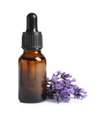 Bottle of essential oil and lavender flowers on white background