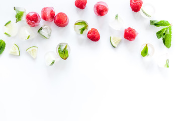 Berries frozen in ice cubes flat lay frame copy space