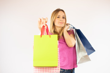 Pretty shopping woman in pink shirt with bags in hand