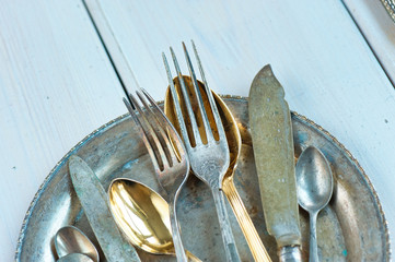 Vintage silverware on rustic wooden background. Top view of kitchen cutlery setting on grunge...