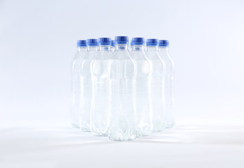 Plastic bottles with pure water on white background