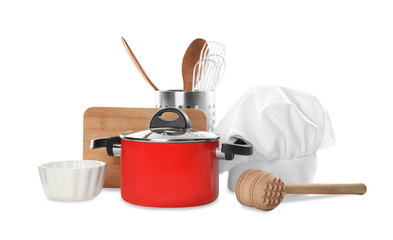 Set of different cooking utensils and chef's hat on white background
