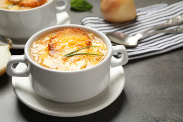 Tasty homemade french onion soup served on grey table
