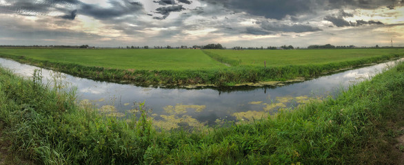 Meadows in the polder. View on Nijeveen. Canal Border of  Steenwijkerland and Meppel. Border of Drenthe and Overijssel.
