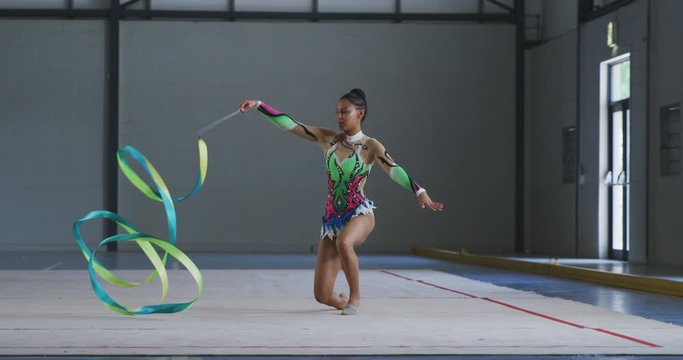Female gymnast performing at sports hall