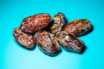a bunch of fresh dates spread in a blue background