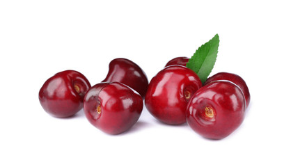 Tasty ripe red cherries with green leaf isolated on white