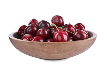 Tasty ripe red cherries in wooden bowl isolated on white