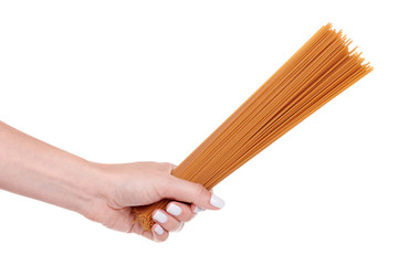 Hand with dark durum wheat spaghetti, raw pasta, isolated on white background.