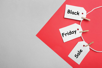 Blank tags on color background, flat lay with space for text. Black Friday concept