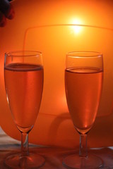 Wine glasses on orange background