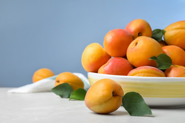 Delicious fresh ripe apricots on white table. Space for text
