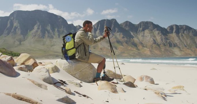 Sporty mixed race man with prosthetic leg hiking