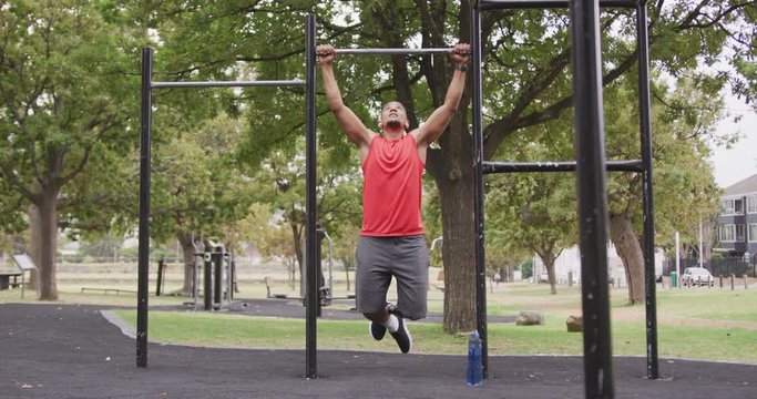 Front view man with prosthetic leg doing pull ups
