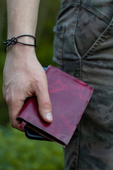 close up of a man holding a notebook
