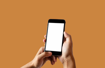 Fototapeta na wymiar Hand holding white mobile phone with blank white screen Orange background. 