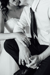 close-up portrait of the bride and groom. They hug their arms. Wedding rings on their hands