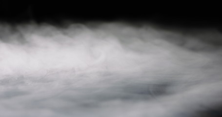 Obraz na płótnie Canvas heavy thick fog filling a black background.