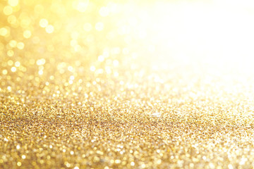 gold Sparkling Lights Festive background with texture. Abstract Christmas twinkled bright bokeh defocused and Falling stars. Winter Card or invitation	 - obrazy, fototapety, plakaty