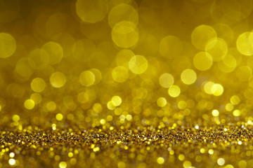 gold Sparkling Lights Festive background with texture. Abstract Christmas twinkled bright bokeh defocused and Falling stars. Winter Card or invitation	