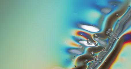 Bubbling Metallic Sheet. Metallic sheet being depressed onto a surface, forming bubbles and a...