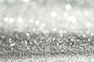 silver Sparkling Lights Festive background with texture. Abstract Christmas twinkled bright bokeh defocused and Falling stars. Winter Card or invitation	