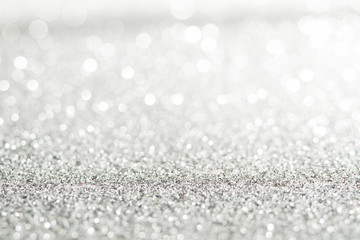 silver Sparkling Lights Festive background with texture. Abstract Christmas twinkled bright bokeh defocused and Falling stars. Winter Card or invitation	