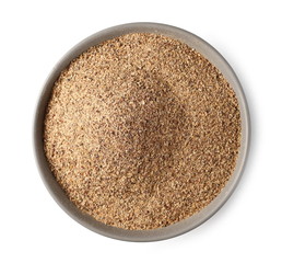 Ground carob powder (Ceratonia siliqua) in porcelain bowl isolated on white background, top view