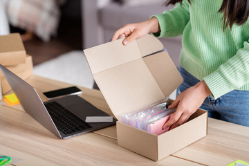 Cropped view of her she focused girl seller packing parcel trade e-commerce order sme drop-shipping industry distribution marketplace cell phone cases assortment home-based office