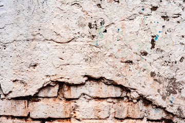 Weathered texture of stained old dark white and orange brick wall background