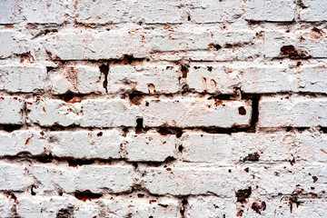 Weathered texture of stained old dark white and orange brick wall background