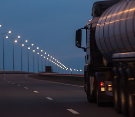 truck with a tanker moves on a night highway