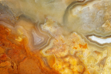 Supermacro image of translucent light agate in orange siliceous rock. Natural stone background.