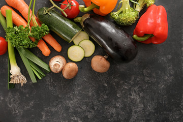 Colorful organic vegetables on a dark gray background with copy space, healthy eating concept, high angle view from above