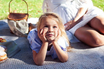 little cute blond girl outside having fun on picnic, lifestyle people concept