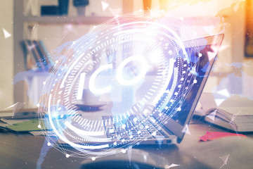 Multi exposure of blockchain theme hologram and table with computer background. Concept of bitcoin crypto currency.