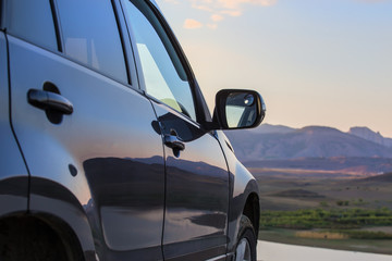 Car in nature against the backdrop of a mountain landscape