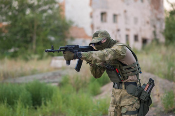 A professional airsoft player aims at his opponents