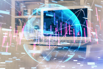 Financial graph colorful drawing and table with computer on background. Double exposure. Concept of international markets.