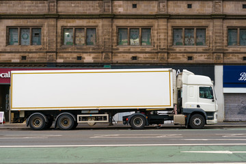 White truck park in british town. Blank empty billboard, perfect for advert.