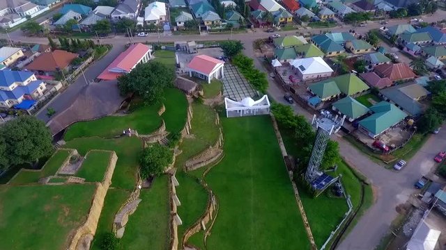 Aerial view rising away from the Acropolis Park, during golden hour, in Apo, Abuja - Pull back, tilt up, drone shot