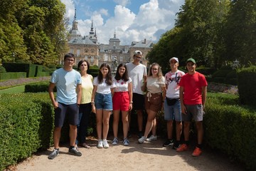 Woman and her seven children from a large family in the gardens of La Granja de San Ildefonso Palace 18th century Royal Palace in the province of Segovia in Spain
