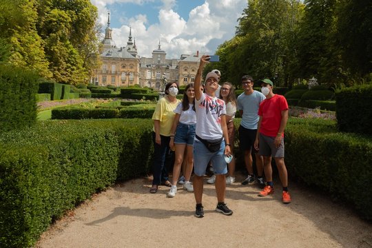 Woman and her seven children from a large family taking a selfie photograph in the gardens of La Granja de San Ildefonso Palace 18th century Royal Palace in the province of Segovia in Spain
