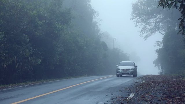 car running on foggy moutain highway chiang mai northern thailand